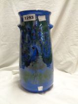 A large Lemon & Crute Torquay pottery vase with hand painted peacock decoration on a blue ground
