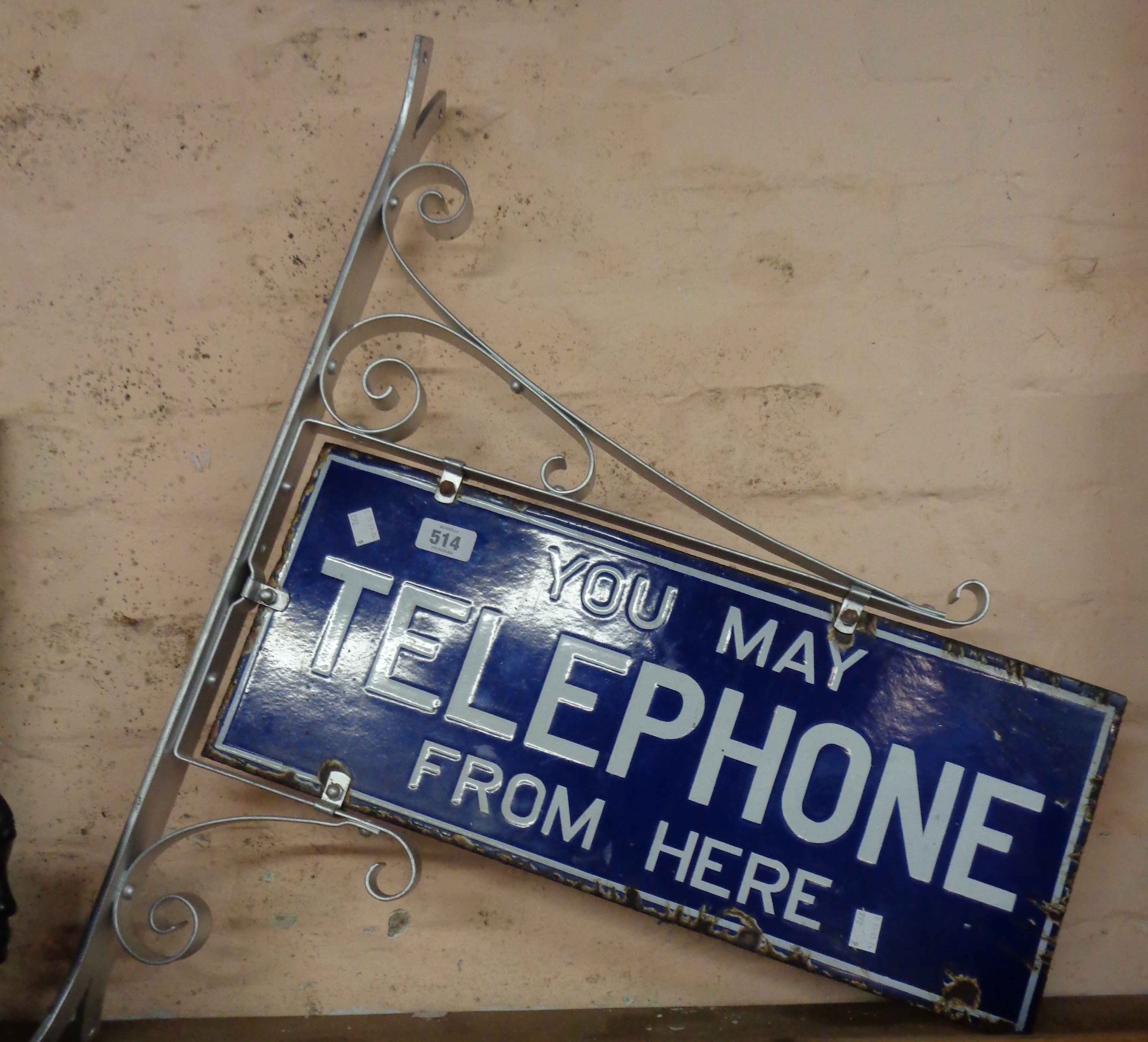 An original G.P.O. Telephone enamel sign and wall mounting bracket, with white lettering on blue