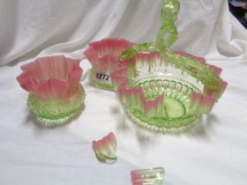 A 19th Century coloured glass basket with wavy rim and applied tree form handle, uranium green