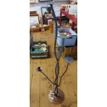 A modern wrought metal floor standing five branch candle holder with sconce and pricket holders