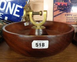 A turned hardwood bowl with central brass ship's wheel pattern nutcracker - by H.C. Crutchley of