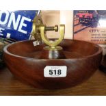 A turned hardwood bowl with central brass ship's wheel pattern nutcracker - by H.C. Crutchley of