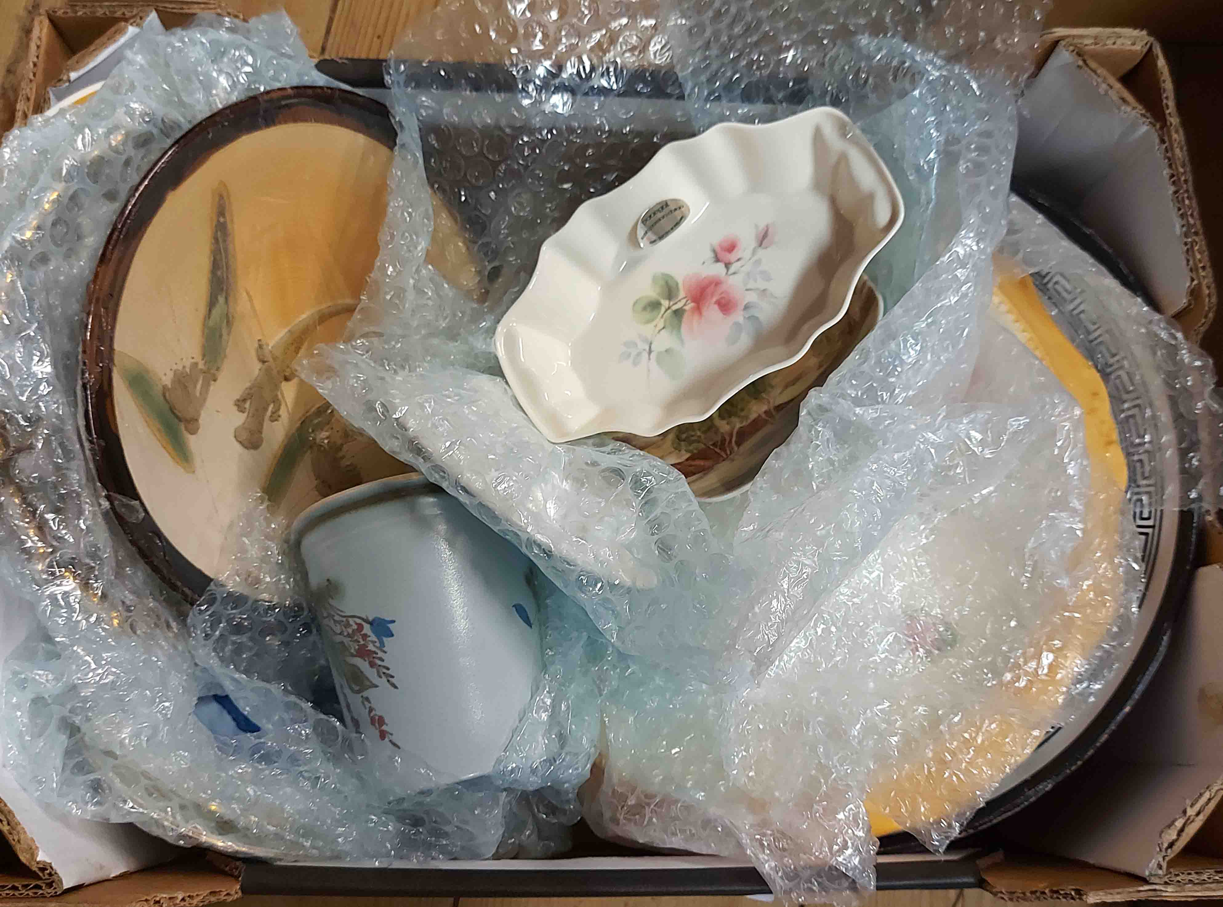 A box of containing a quantity of ceramics