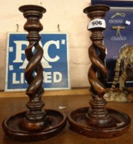 A pair of wooden open twist candlesticks