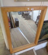 A large modern stained wood framed oblong wall mirror
