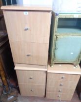 A pair of small modern woodgrain effect two drawer filing chests - sold with a chest of four drawers