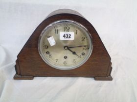 A vintage oak cased mantel clock with Garrard eight day chiming movement