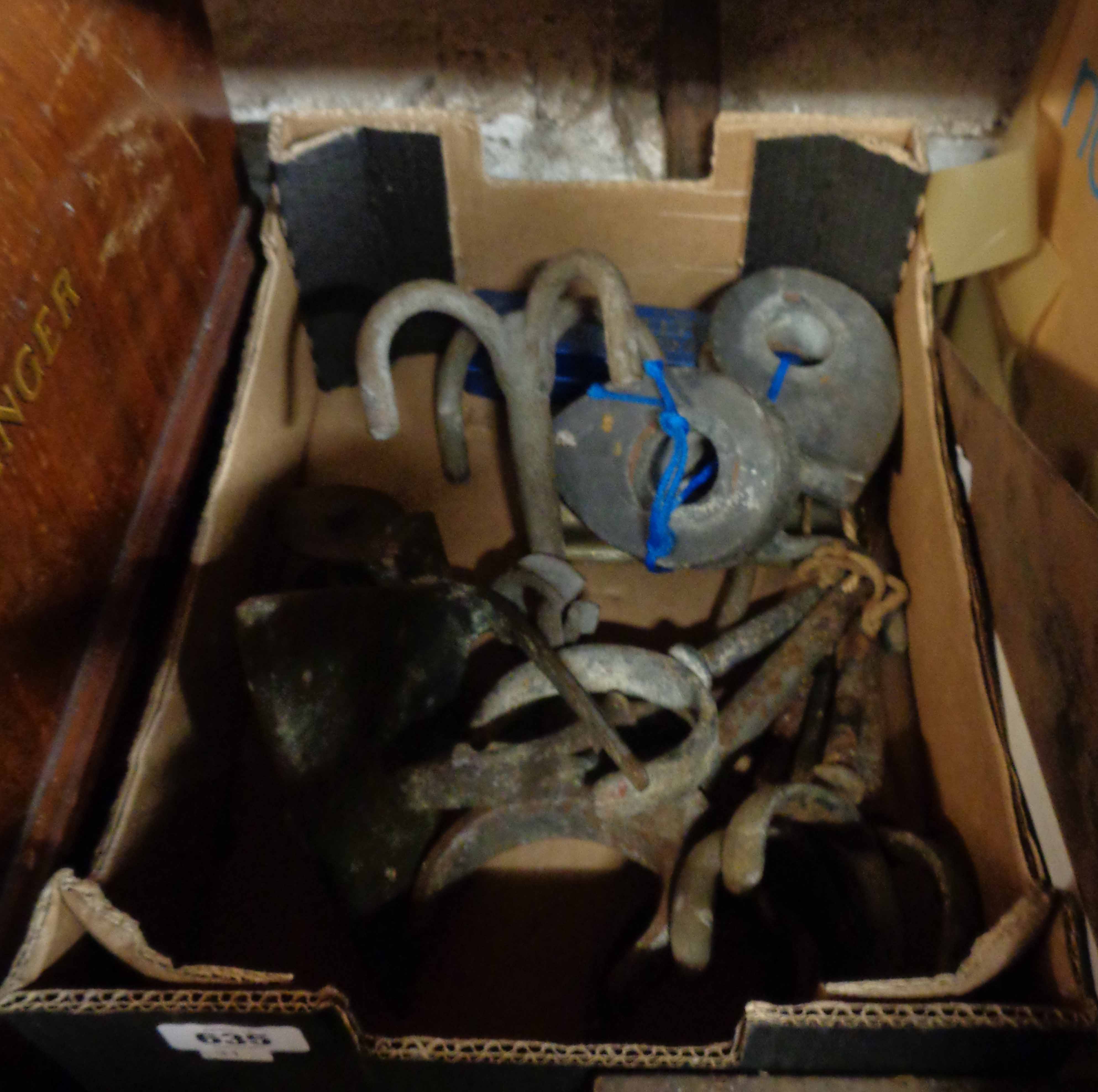 A box containing boat rowlocks, hooks, etc.