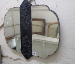 A 1930's stained oak wall mirror with decorative central carved decoration and flanking shaped and