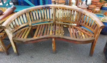 A teak garden bench with curved back - seat a/f