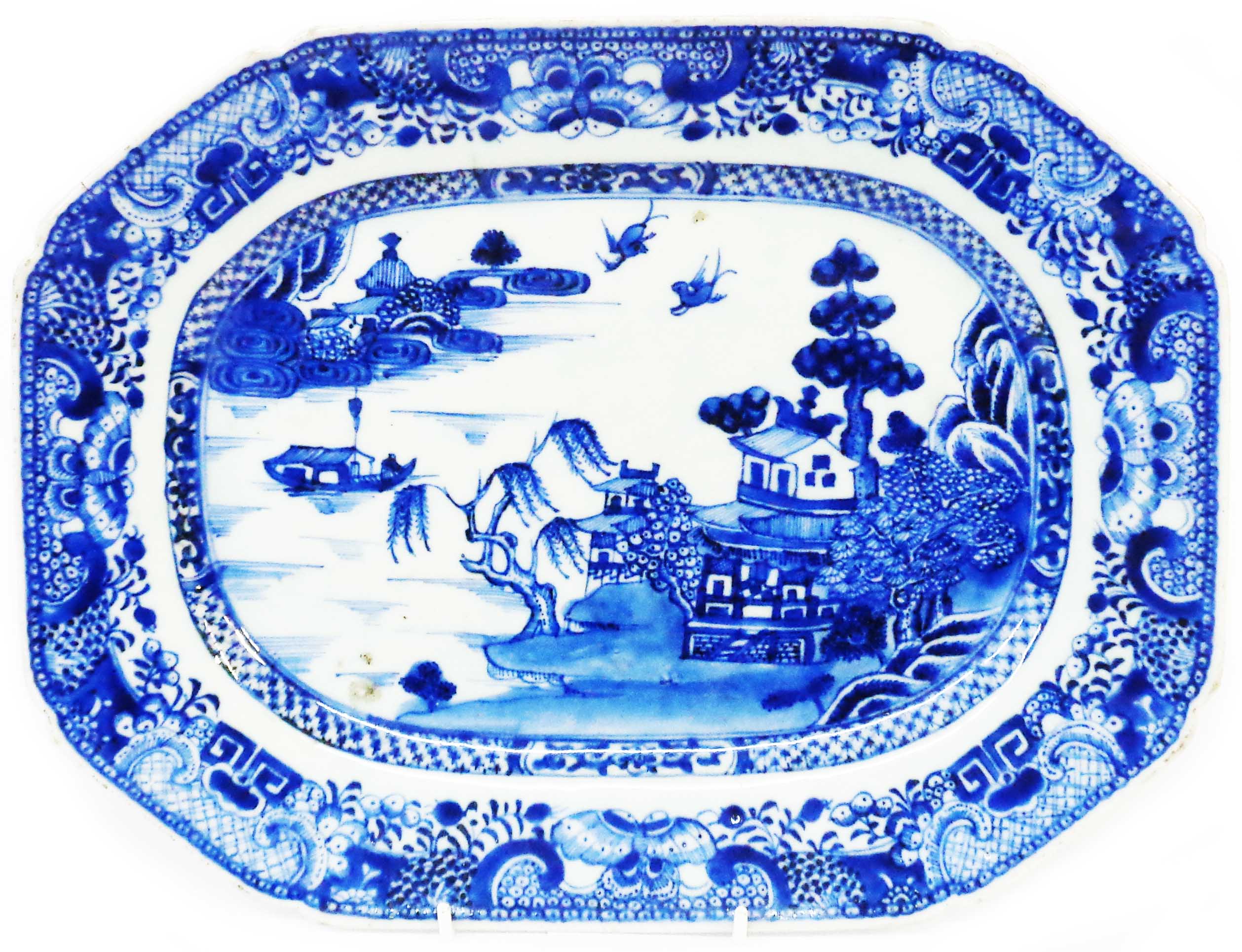 An antique Chinese porcelain meat plate, with blue hand painted Willow pattern decoration