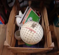 A box of golf related items including novelty musical golf ball decanter, etc.