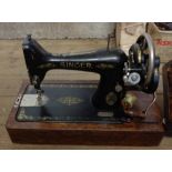 A vintage Singer sewing machine set within dome case