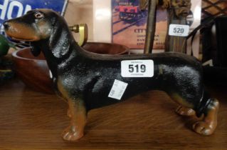 A modern cast iron dachshund form doorstop