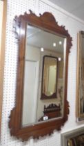 A 1.03m high 19th Century walnut veneered fret-cut wall mirror with gilt border and bevelled plate
