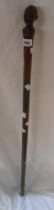 A vintage African wooden walking stick with carved man's head finial and specimen wood shaft