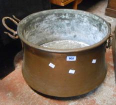 A large beaten copper two handled pot