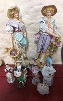 A pair of large 19th Century German porcelain figurines, depicting a man and woman picking grapes (1