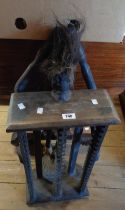 A carved wood CD rack with African tribal figure