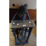 A carved wood CD rack with African tribal figure