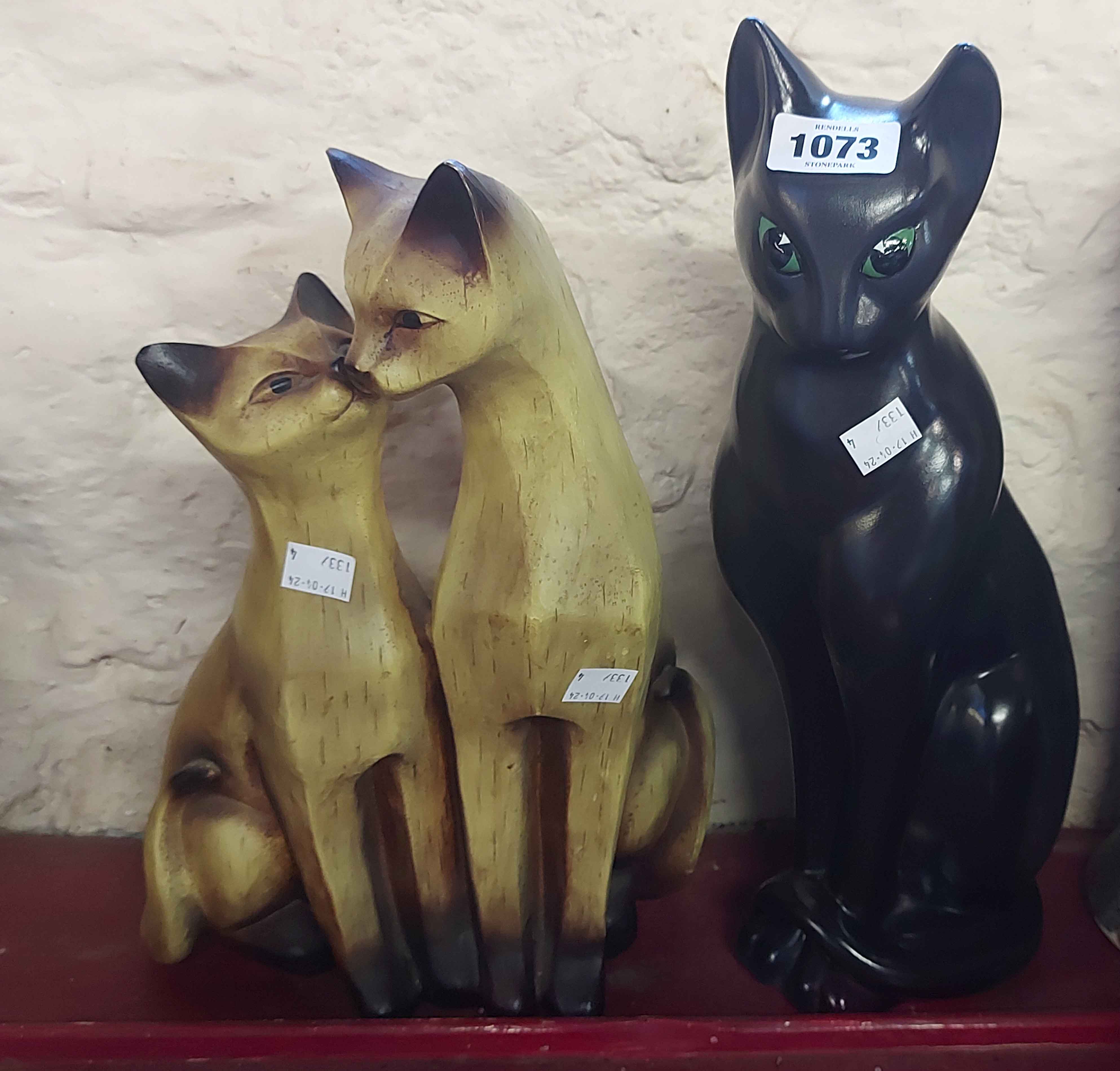 A large ceramic figurine, depicting a stylised seated cat with painted finish - sold with a