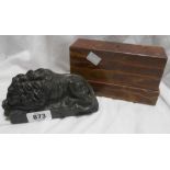 An Italian carved green serpentine marble recumbent Lion of Lucerne, set on an associated brown