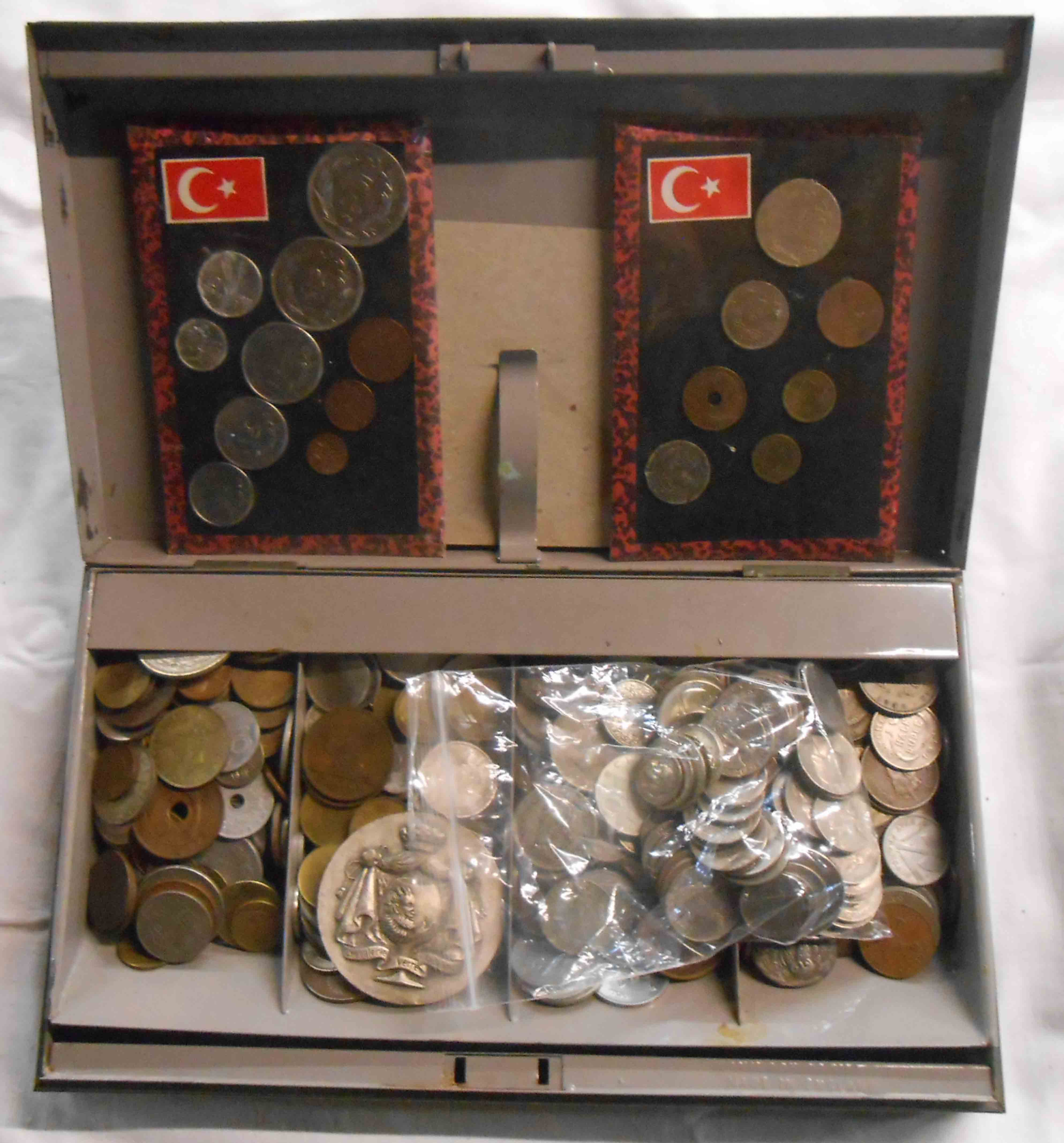 A metal cash tin containing a collection of mainly 20th Century world coinage, numerous USA