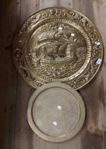 A large embossed brass tray with galleon decoration - sold with a smaller Eastern chased brass