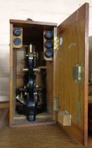 A vintage Watsons microscope set in original fitted case containing a quantity of glass slides and