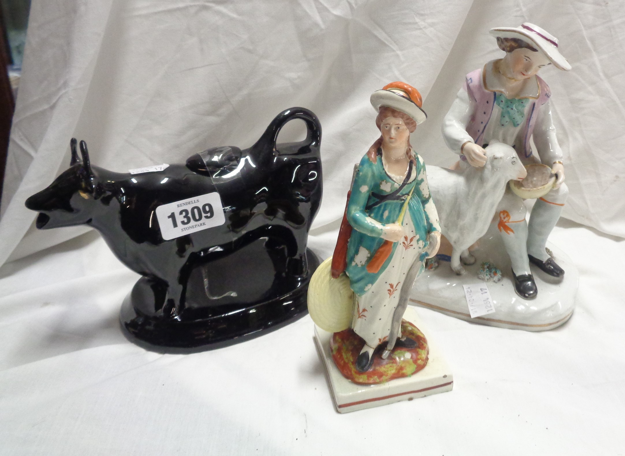 A late 18th/early 19th Century Staffordshire creamware figurine, depicting a female archer (paint