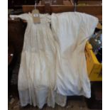 Three antique christening gowns including silk and other examples