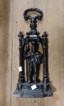 A 19th Century cast iron door stop with central pierced knight figure and handle to top