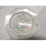 An antique Chinese porcelain plate of octagonal form with famille rose decoration, depicting