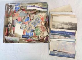 A tin containing a collection of mainly 20th Century loose and on paper GB and world stamps, some