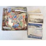 A tin containing a collection of mainly 20th Century loose and on paper GB and world stamps, some