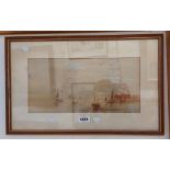 A framed watercolour, depicting moored sailing fishing vessels and shoreside buildings -