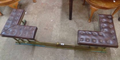 A 1.31m antique brass two seater club fender with upholstered seats