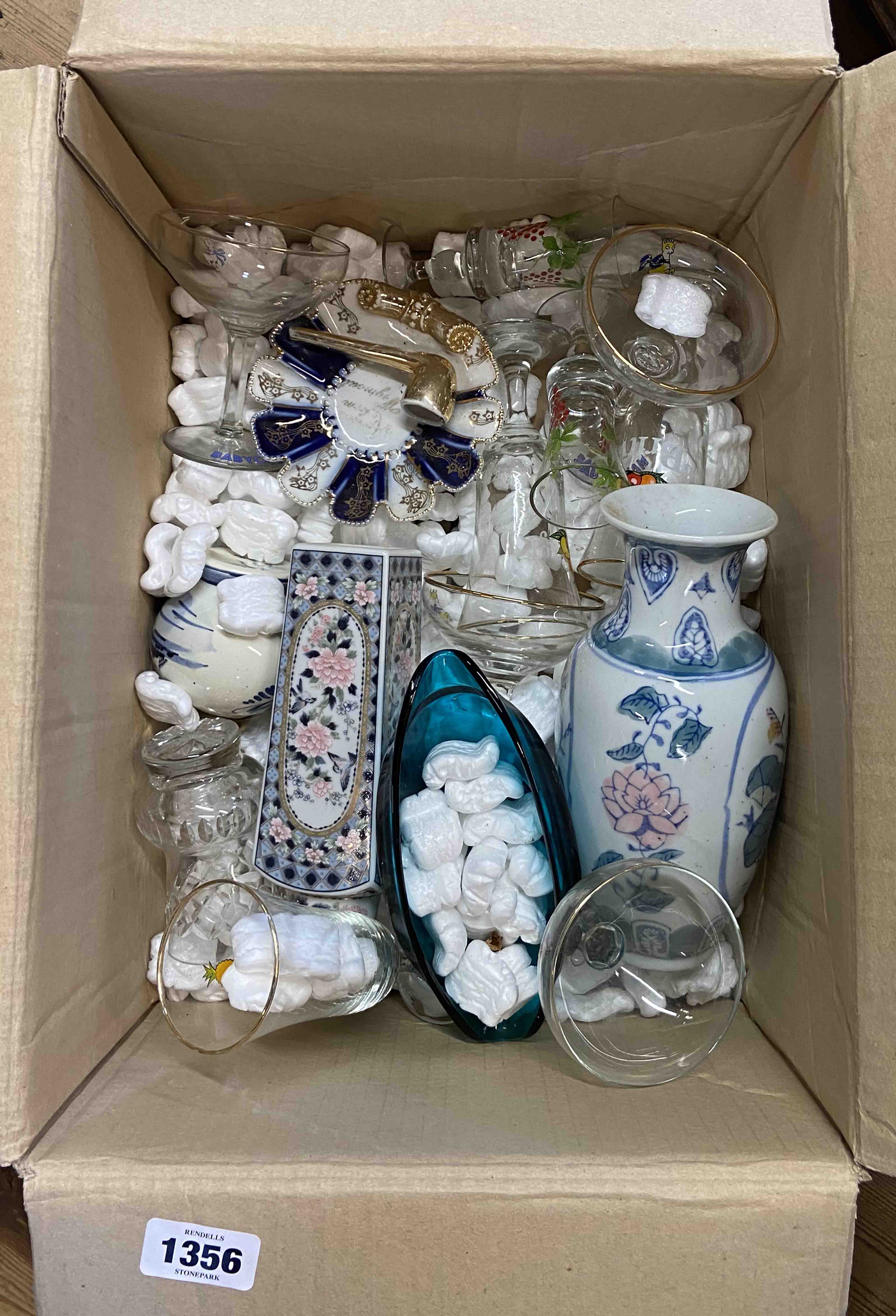 A box containing a quantity of glassware and ceramics including vintage Babycham and Britvic