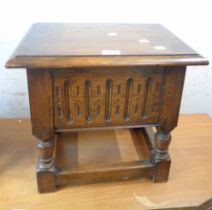 A small vintage carved oak lift-top sewing box, set on turned supports and open stretcher base