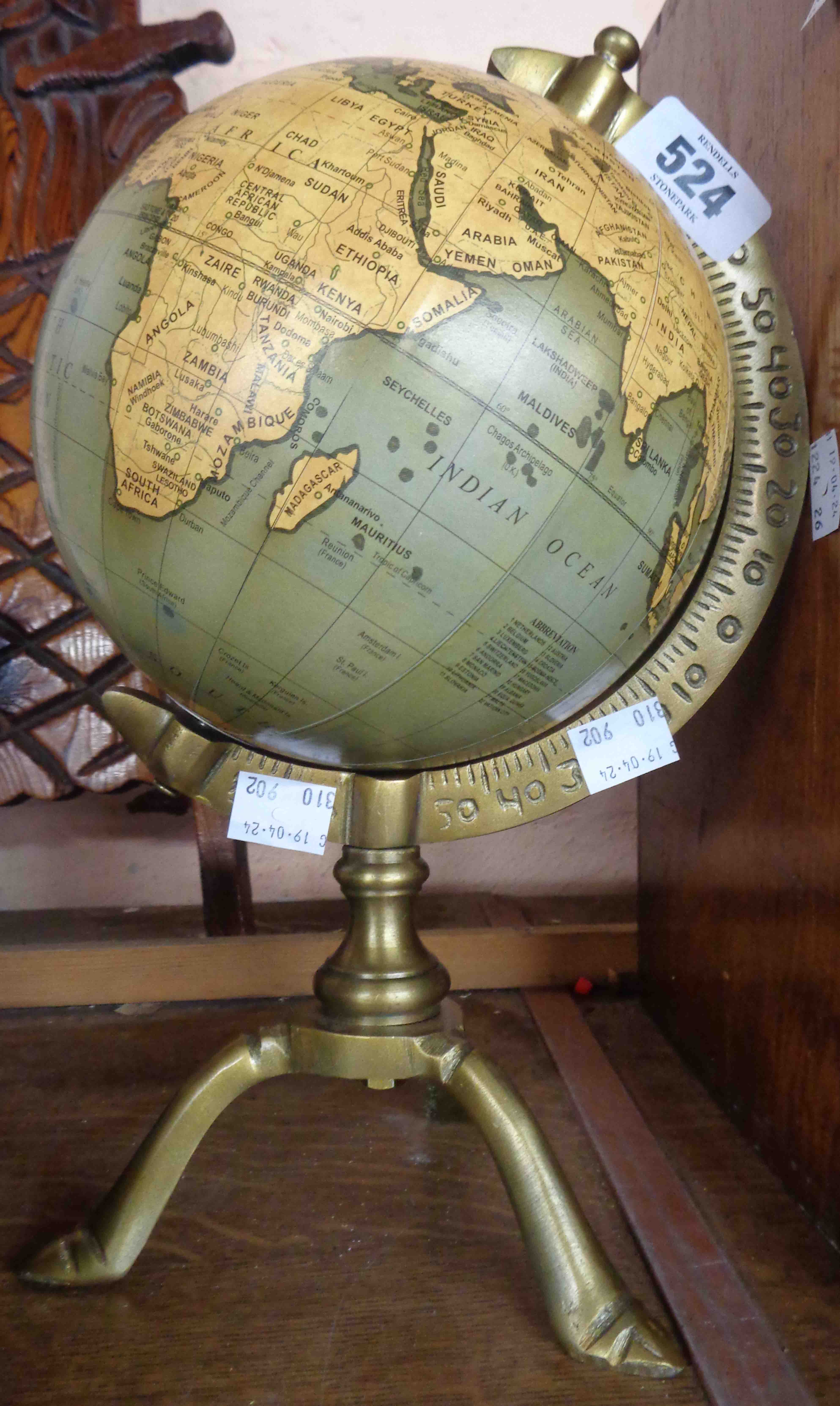 A small modern antique style globe on stand