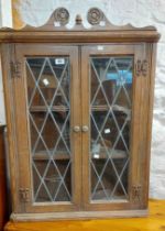 A 69cm Old Charm oak wall hanging corner cupboard with shelves enclosed by a pair of leaded glazed