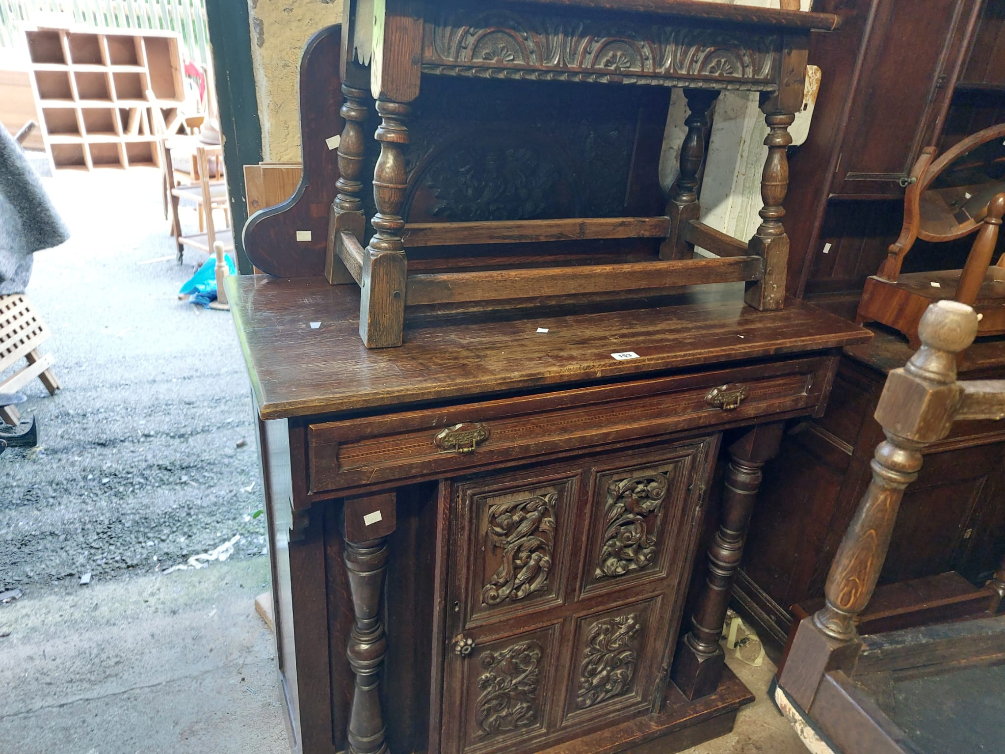 A 98cm late Victorian oak chiffonier with profuse carved decoration to raised back, single frieze