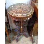 A 54cm diameter old Chinese hardwood occasional table with inlaid decoration depicting figures,