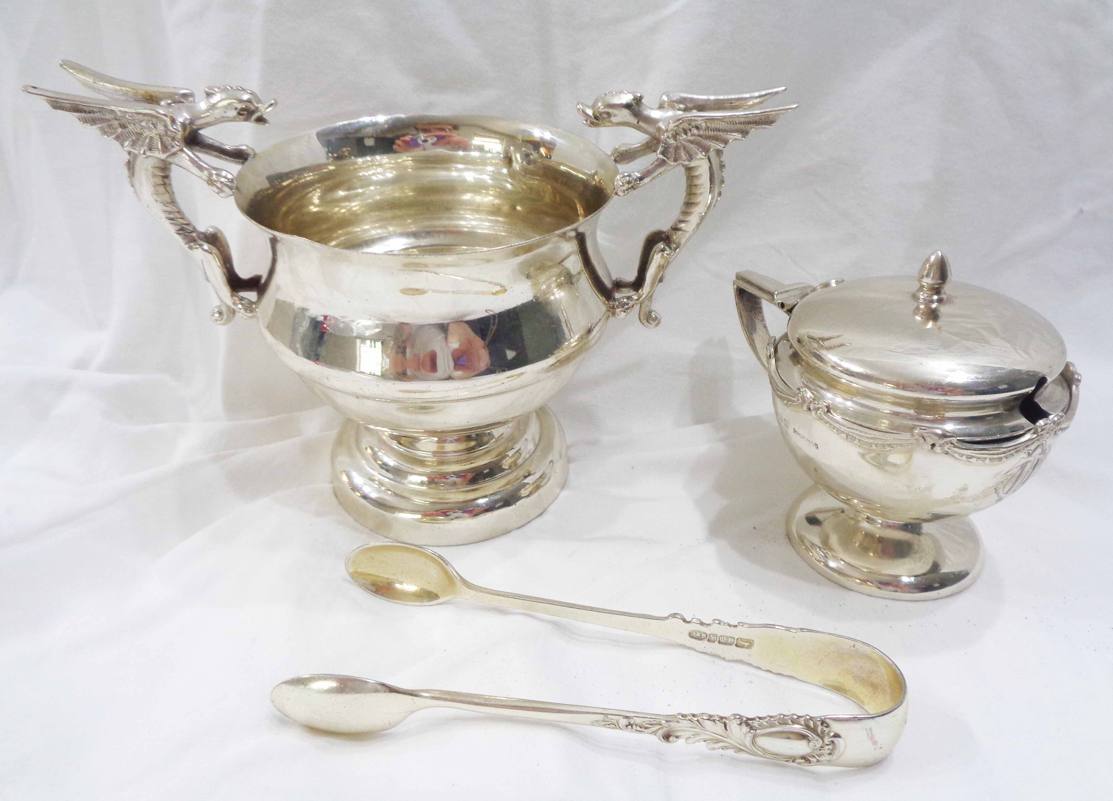 A small silver footed bowl with flanking cast gryphon pattern handles - Sheffield 1911 - sold with a