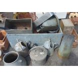 A large galvanised metal water trough - sold with a quantity of metal watering cans and other items