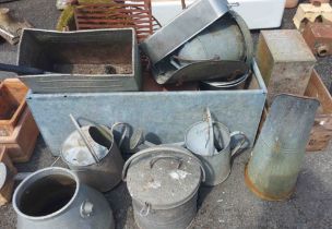 A large galvanised metal water trough - sold with a quantity of metal watering cans and other items