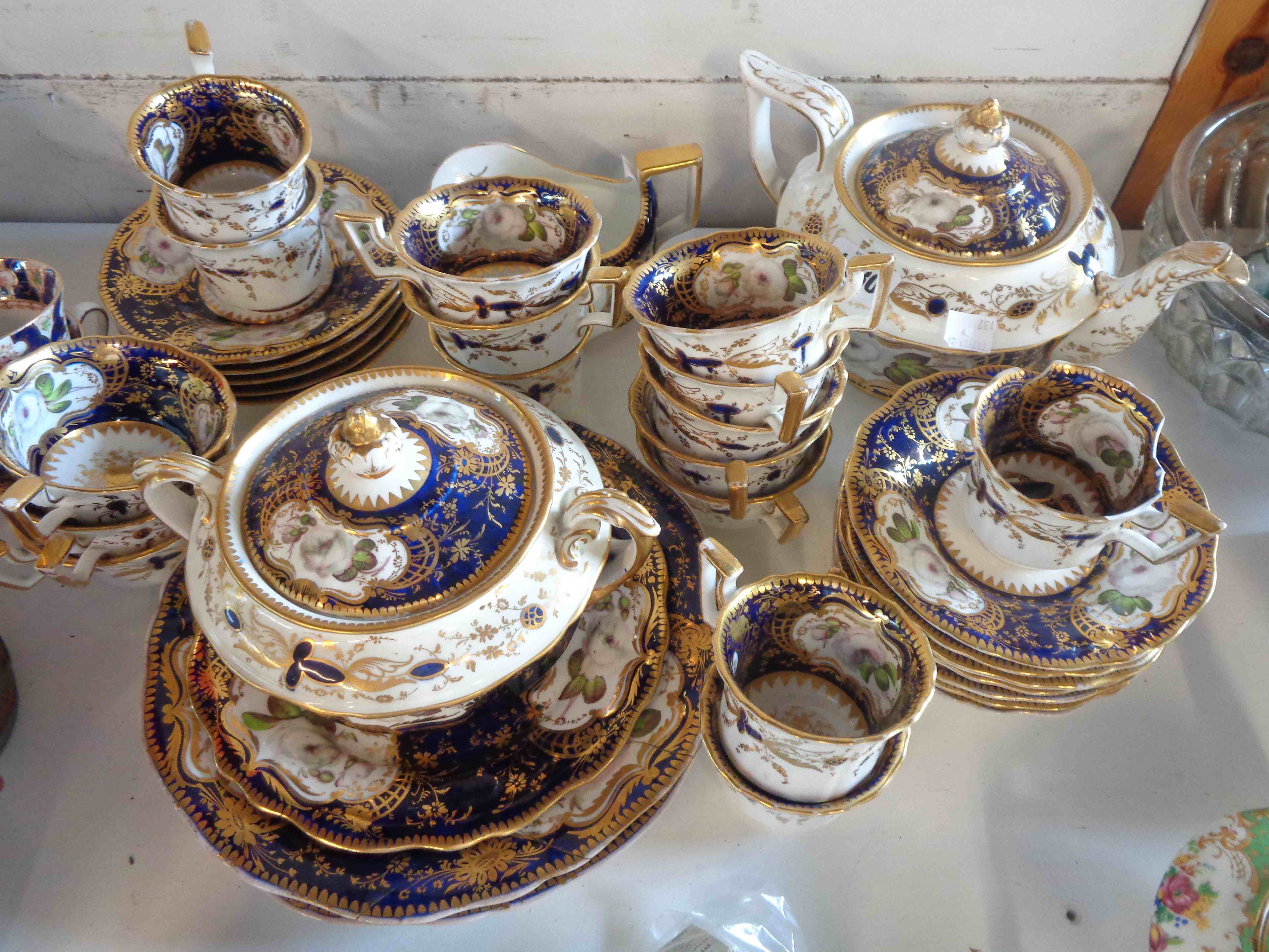 An early 19th Century bone china part tea set in the Rockingham manner, decorated with hand