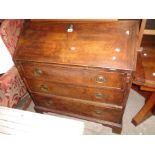 A 99cm late Georgian mahogany bureau with part fitted interior and three long graduated drawers, set