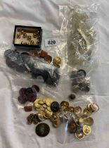 A bag containing a quantity of various buttons including uniform buttons, pressed glass buttons,