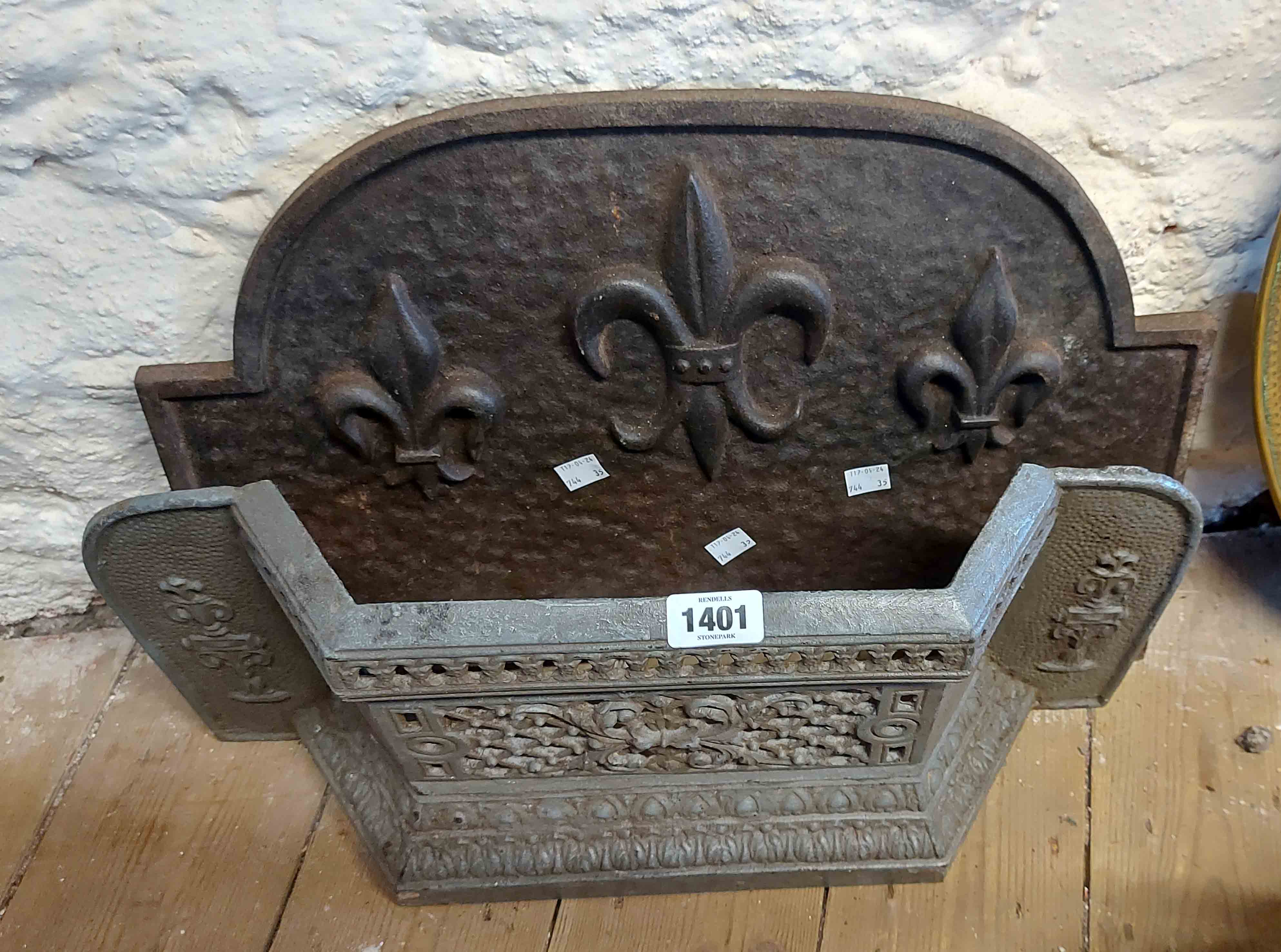 An old cast metal fire grate front - sold with a similar cast iron fire back with fleur de lys